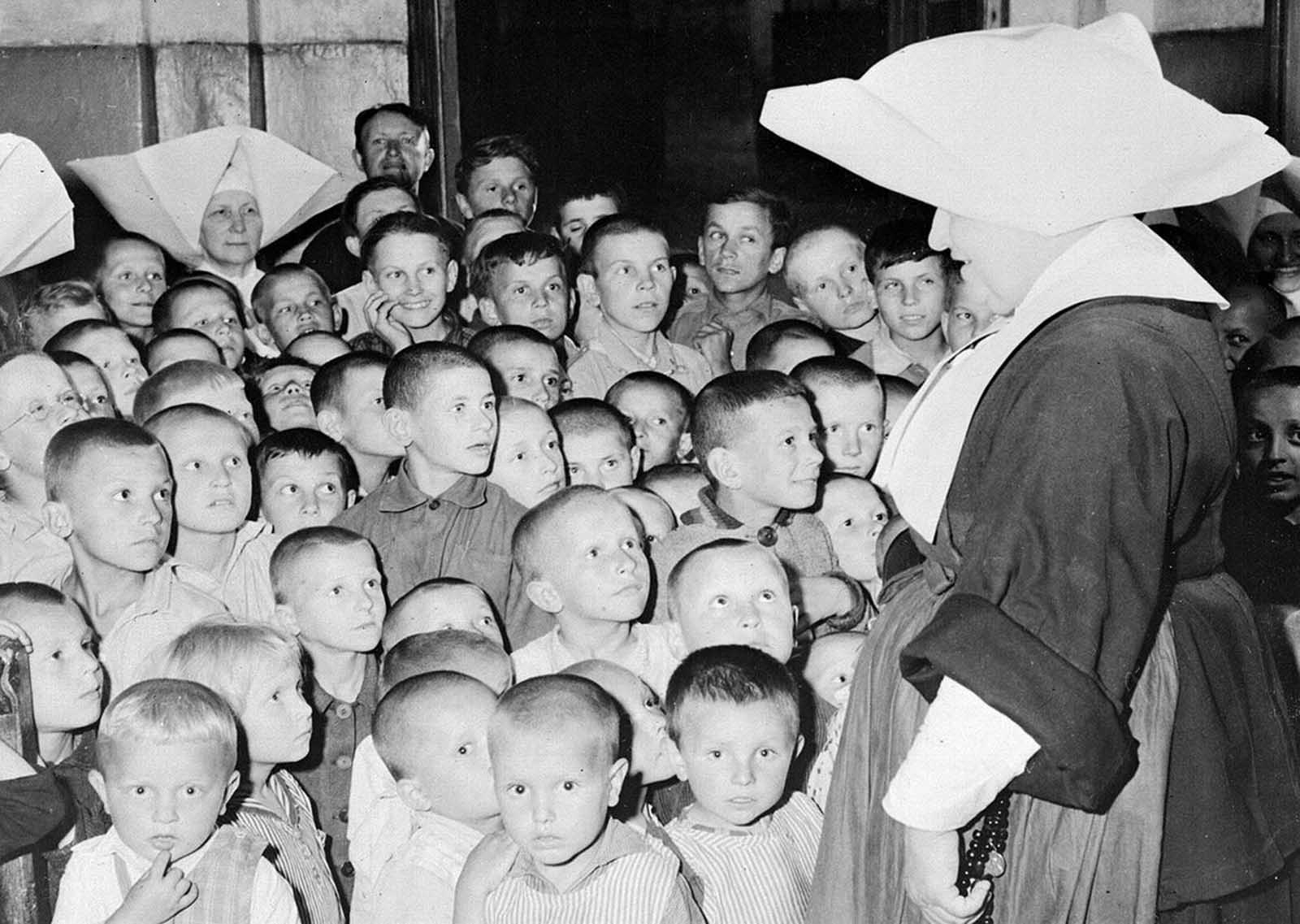 Some of Poland's thousands of war orphans at the Catholic Orphanage in Lublin, on September 11, 1946, where they are being cared for by the Polish Red Cross. Most of the clothing, as well as vitamins and medicines, are provided by the American Red Cross.