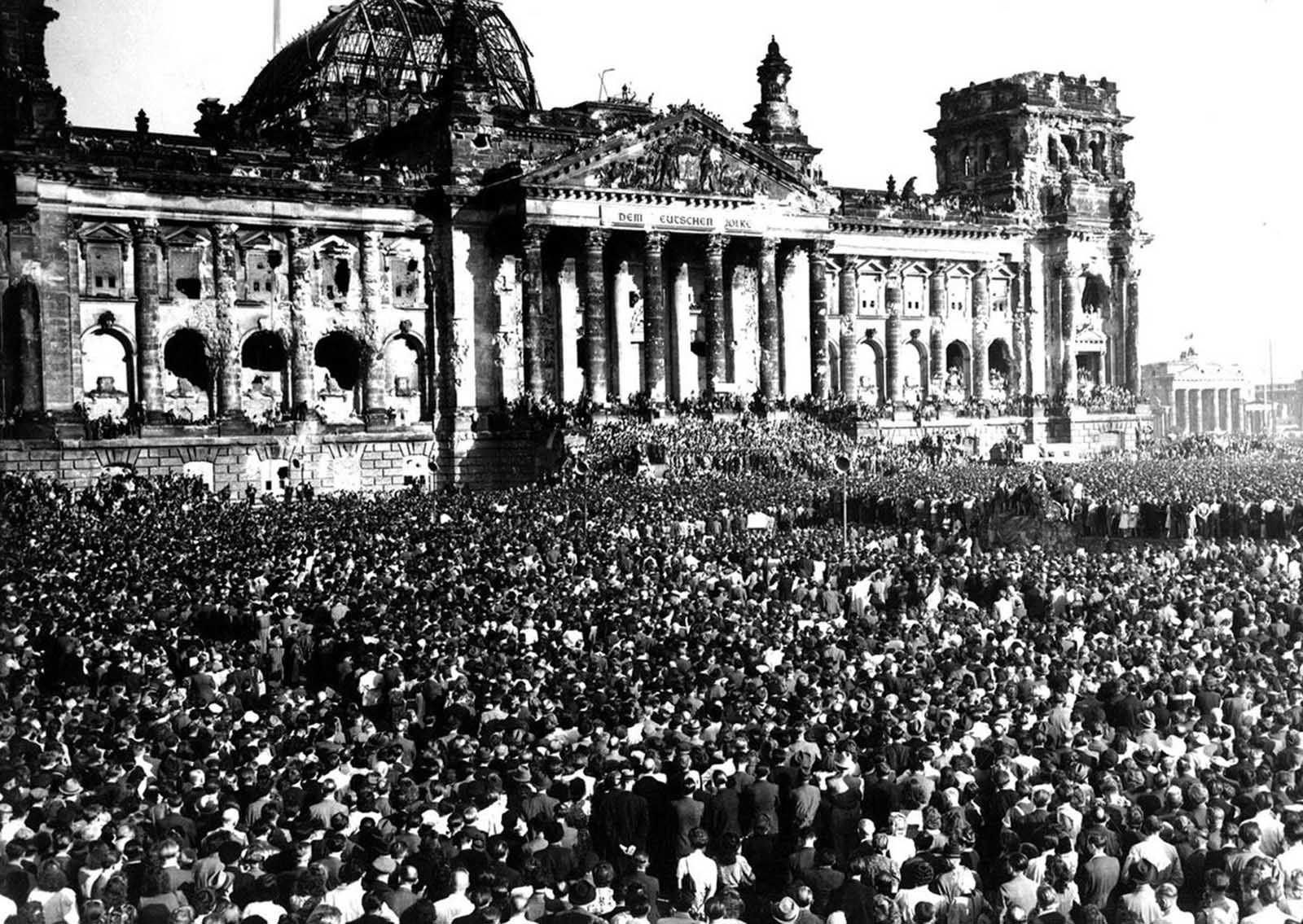 The scene in Berlin's Republic Square, before the ruined Reichstag Building, on September 9, 1948, as Anti-Communists, estimated at a quarter of a million, scream their opposition to Communism. At the time, the Soviet Union was enforcing the Berlin Blockade, blocking Allied access to the parts of Berlin under Allied control. In response, Allies began the Berlin Airlift until the Soviets lifted the blockade in 1949, and East Germany and West Germany were established. When the meeting pictured here broke up, a series of incidents between Anti-Red Germans and Soviet troops brought tension to a fever pitch as shootings took place, resulting in the deaths of two Germans.