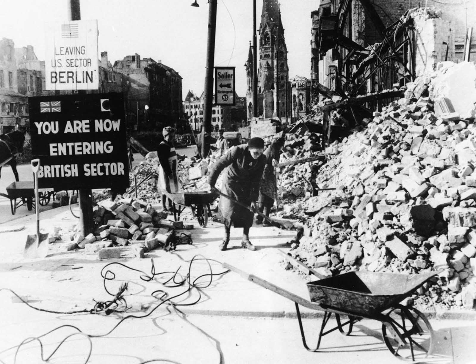 This 1945 photo shows German women clearing up the debris on Berlin's Tauentzienstrasse, with the ruins of the Kaiser Wilhelm Church in the background. The absence of able bodied men meant that the responsibility for clearing the wreckage fell mainly to civilian women, which were called