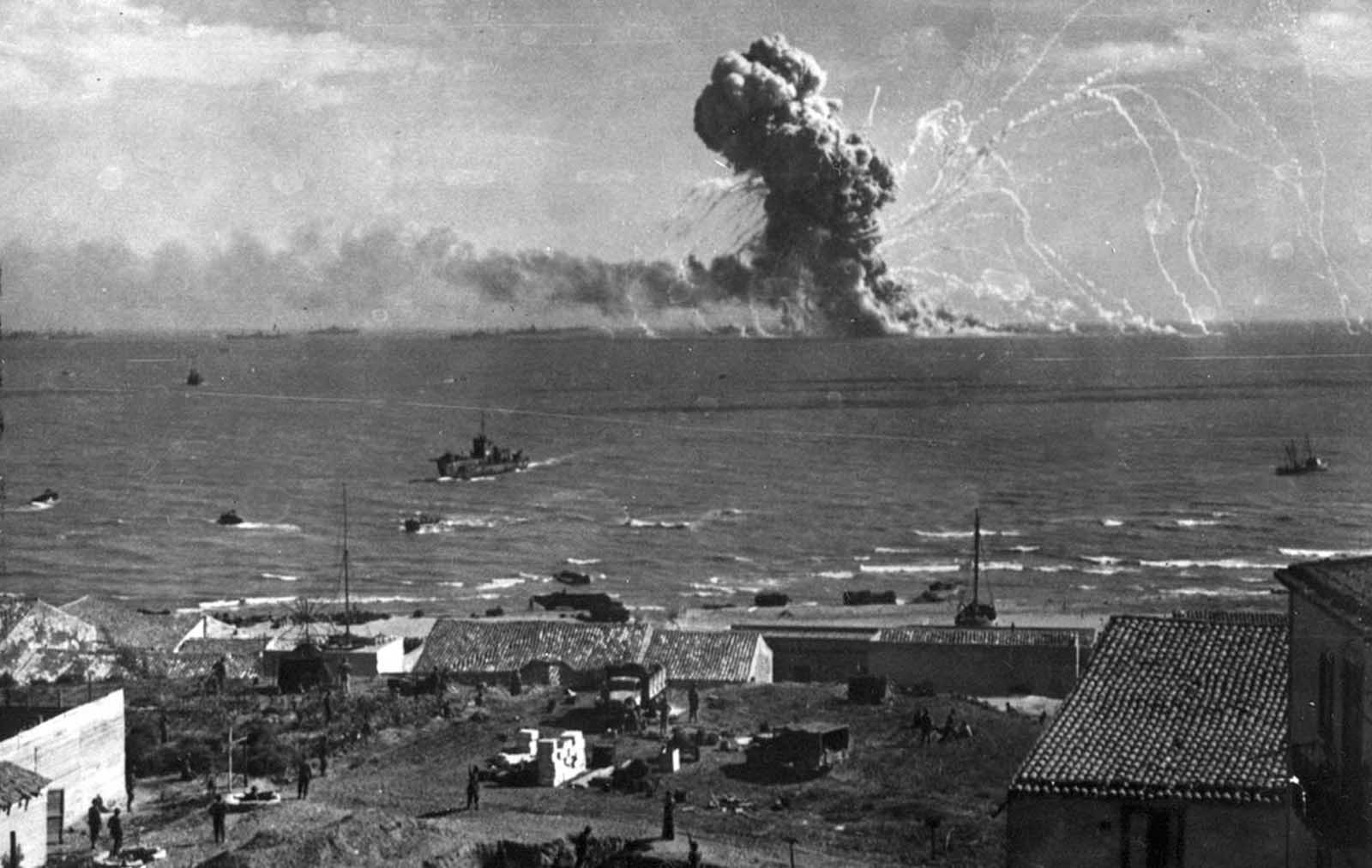 During the invasion of Sicily by Allied forces, an American cargo ship, loaded with ammunition, explodes after being hit by a bomb from a German plane off Gela, on the southern coast of Sicily, on July 31, 1943.