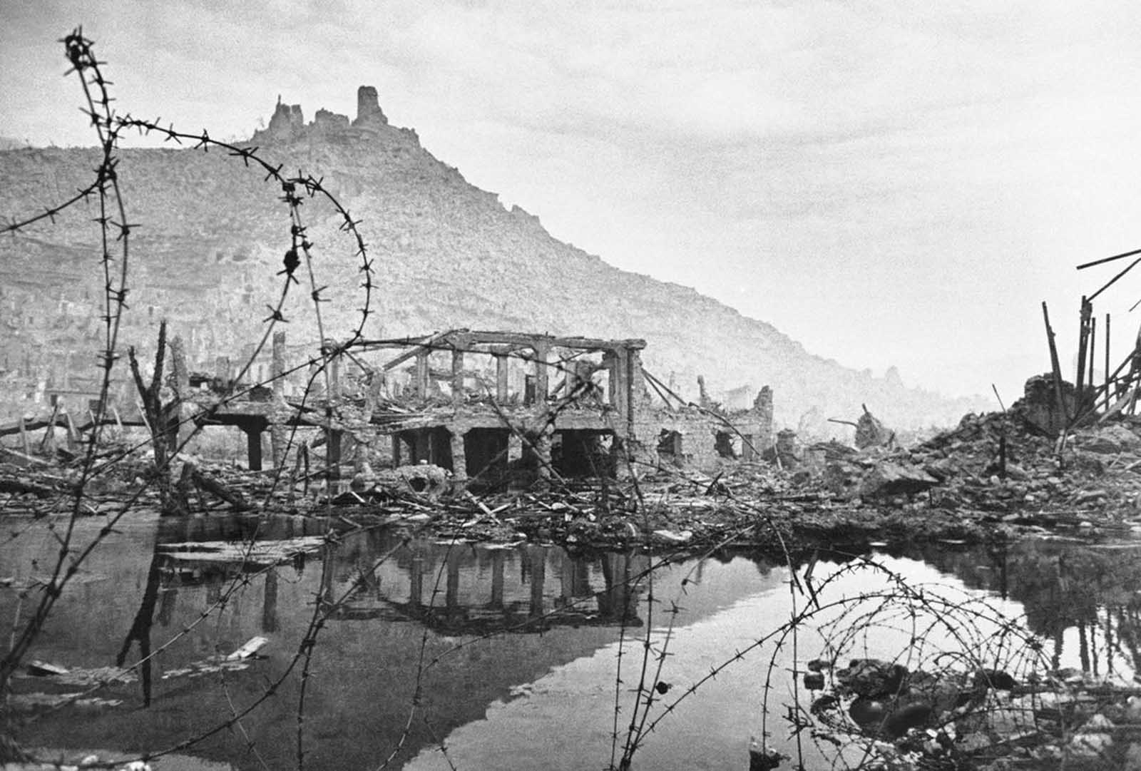 Desolation in the Italian city of Cassino in May of 1944, the day after the city's capture by the Allies. Hangman's Hill is shown in the background, scene of bitter fighting during the long and bitter siege of the stronghold.