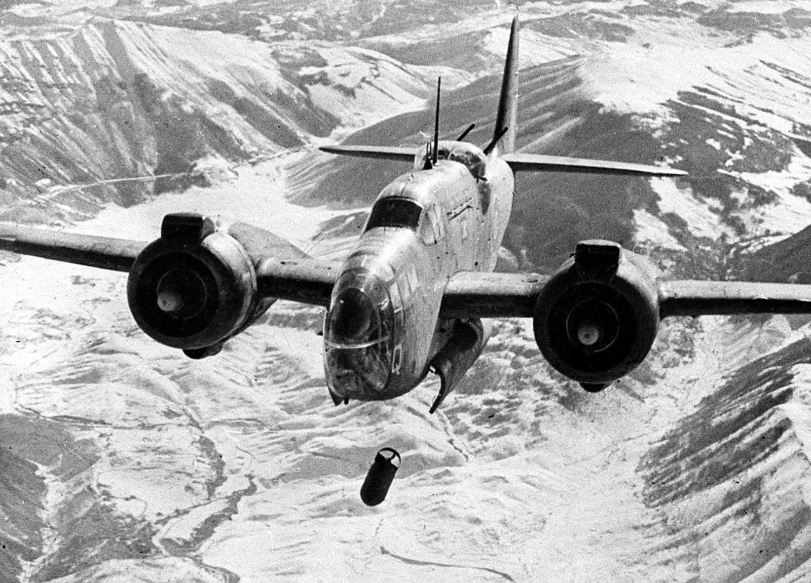 A Royal Air Force Baltimore light bomber drops a series of bombs during an attack on the railway station and junction at the snow-covered town of Sulmona, a strategic point on the east-west route across Italy, in February of 1944.