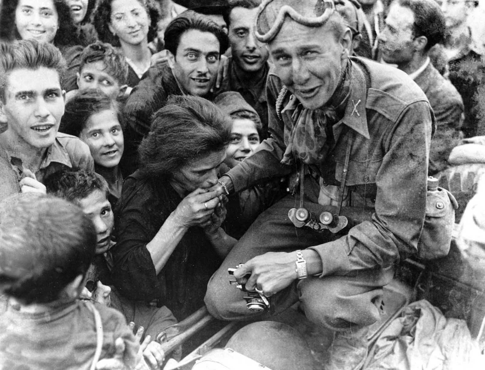 An Italian woman kisses the hand of a soldier of the U.S. Fifth Army after troops move into Naples in their invasion and advance northward in Italy, on October 10, 1943.