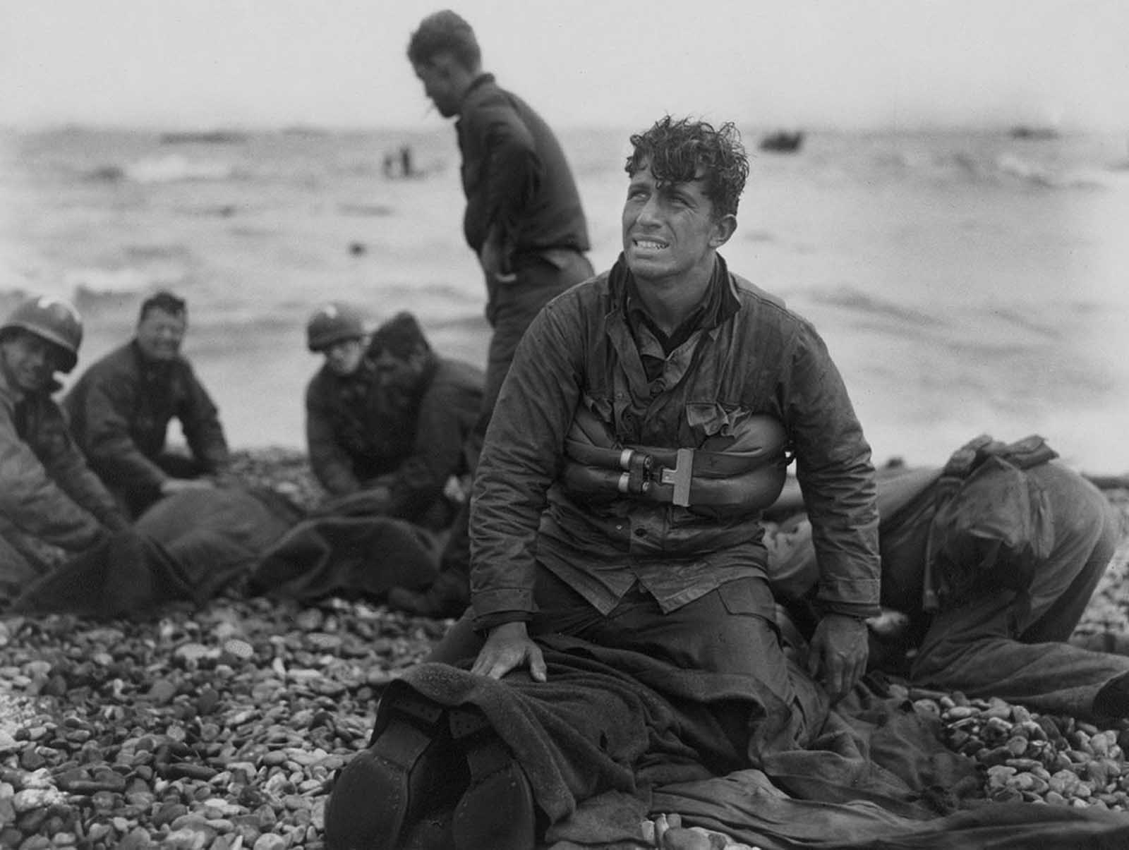 American soldiers on Omaha Beach recover the dead after the June 6, 1944, D-Day invasion of France.