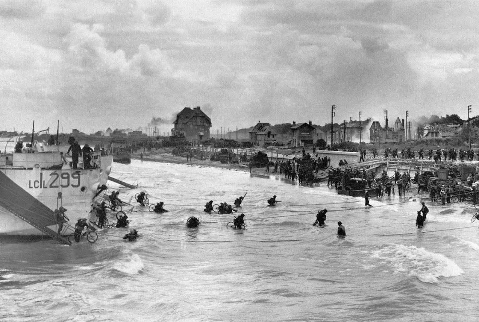 Canadian soldiers from 9th Brigade land with their bicycles at Juno Beach in Bernieres-sur-Mer during D-Day, while Allied forces were storming the Normandy beaches.
