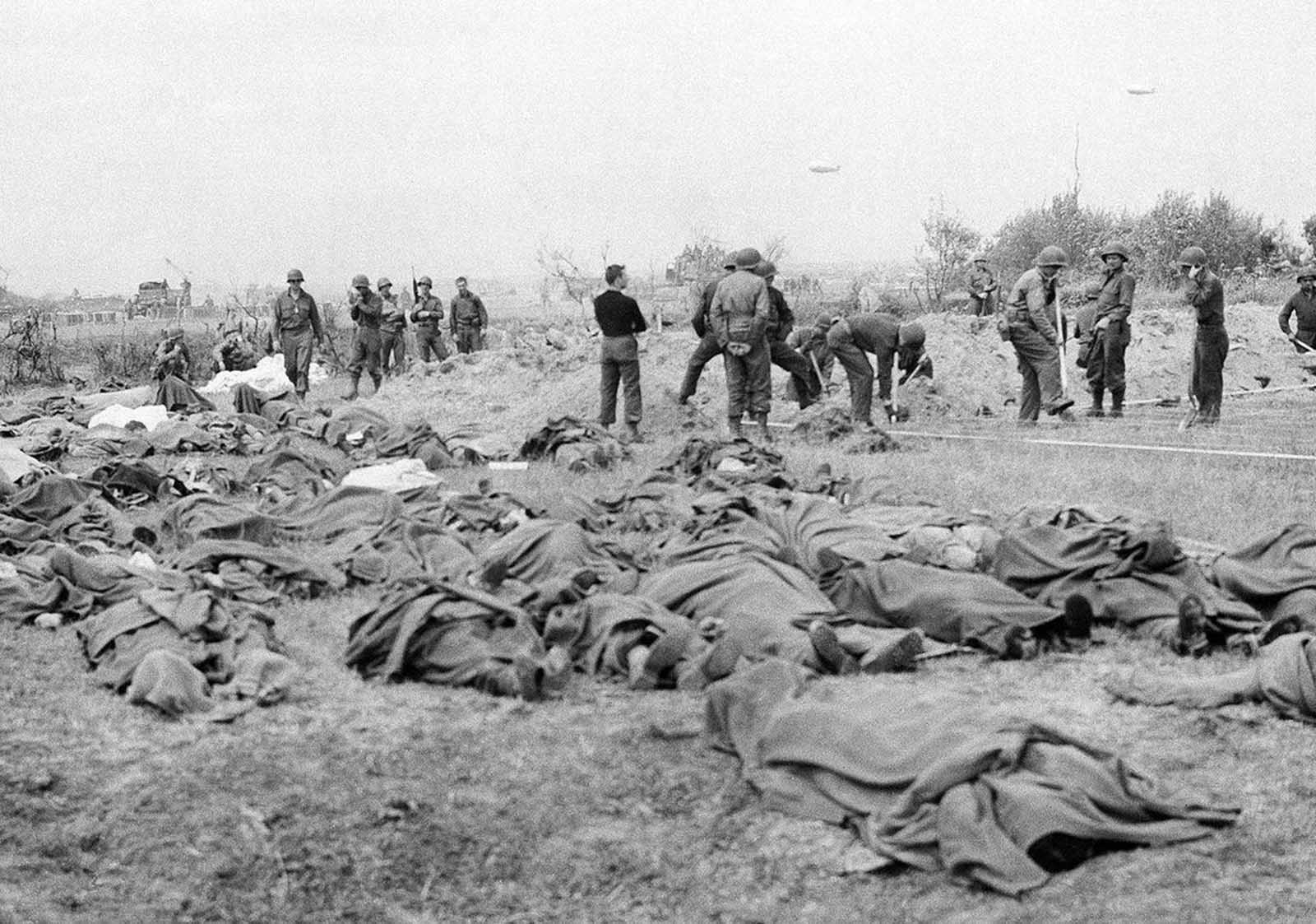 American dead lie in a French field, a short distance from the allied beachhead in France on June 20, 1944.