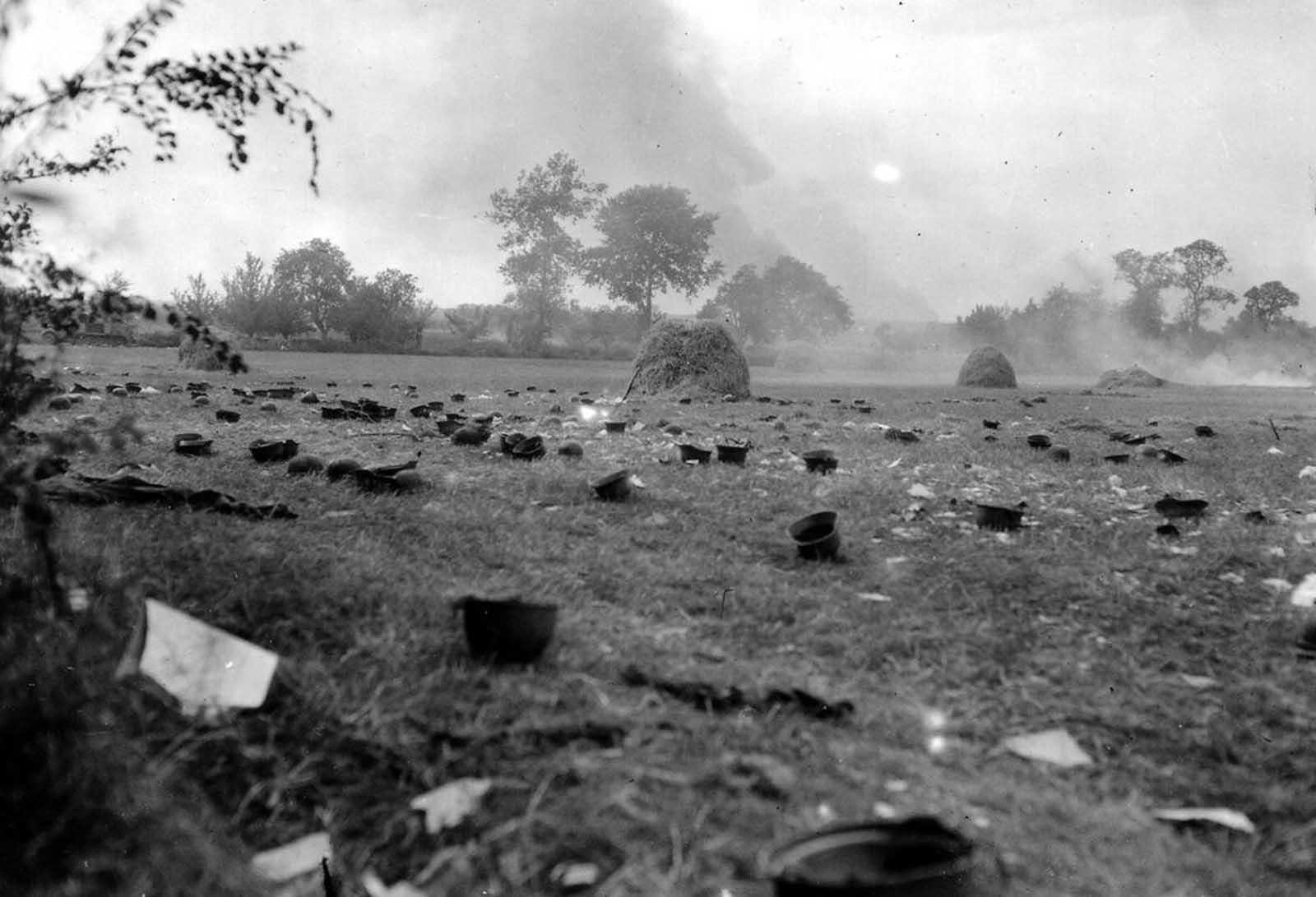 Helmets discarded by German prisoners, who were taken to a prison camp, in a field in Normandy, France in 1944.