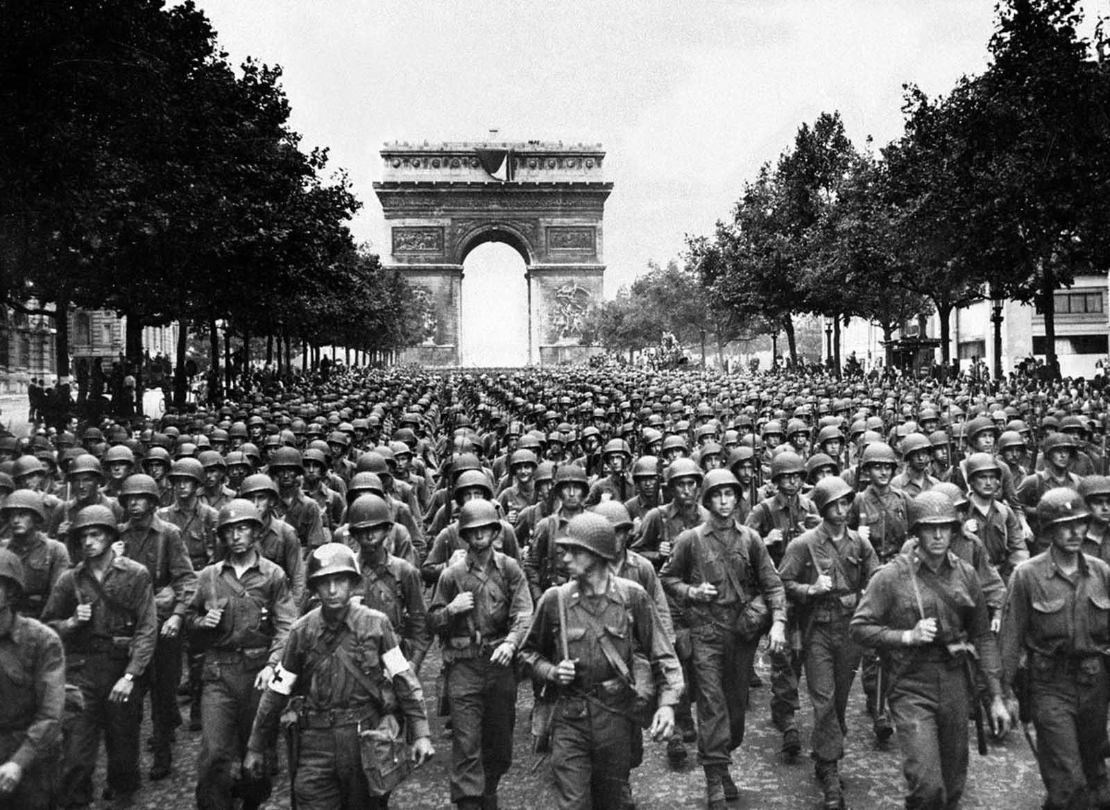 After the French Resistance staged an uprising on August 19, American and Free French troops made a peaceful entrance on August 25, 1944. Here, four days later, soldiers of Pennsylvania's Twenty-eighth Infantry Division march along the Champs-Elysees, with the Arc de Triomphe in the background.