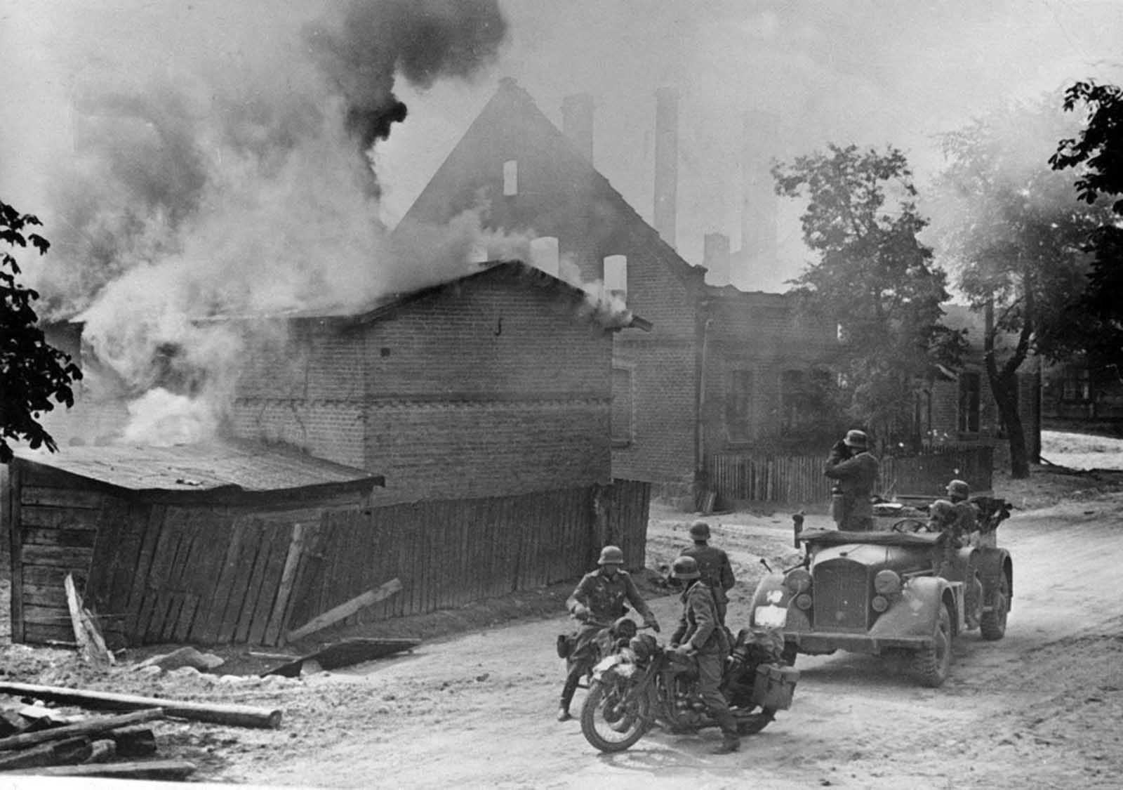 German advance guards and scouts are shown in a Polish town that has been under fire during the Nazi invasion of Poland, September 1939. 