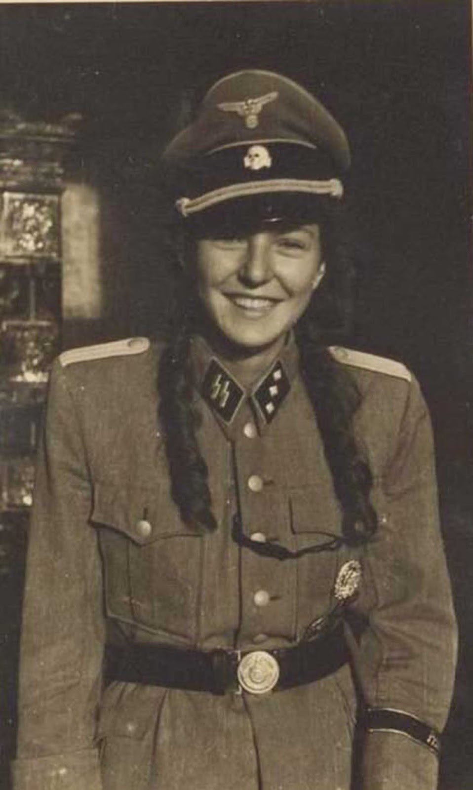 Nobody seems to know where this photo came from. It shows a young lady in an officer's (Untersturmführer) uniform. German soldiers for some reason found it kinky to dress their conquests in their uniforms. Note that the picture is cut off from showing the pants that she probably is not wearing. This may (or may not) be simply innocent girlish fun.