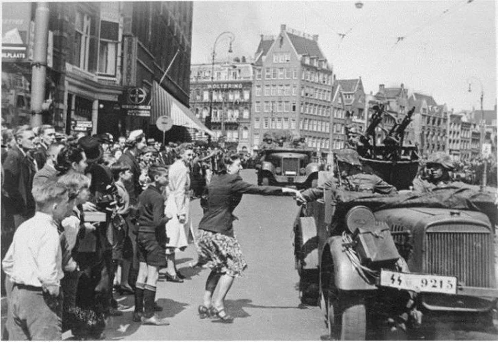 A Dutch girl greets the Wehrmacht boys as they enter Amsterdam, 15 May 1940.