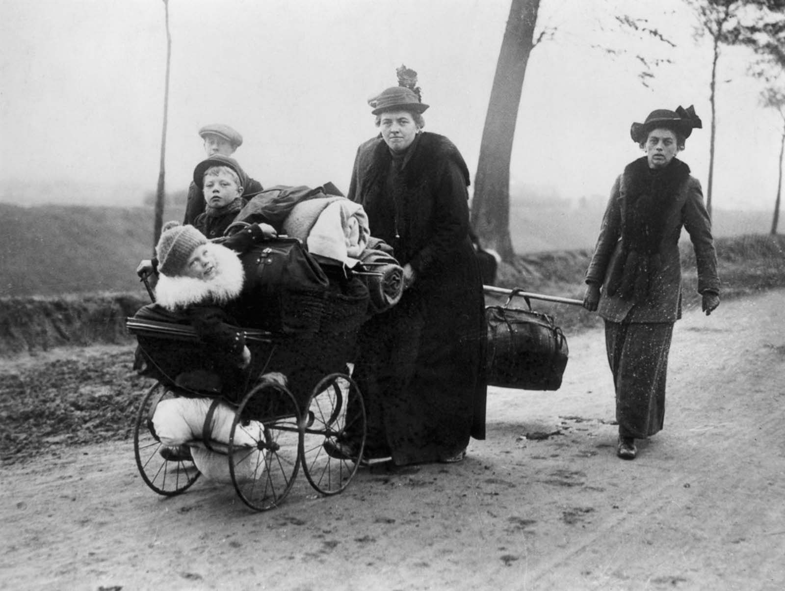 Belgian refugees carry their belongings ahead of invading troops through Northern France. 1914.
