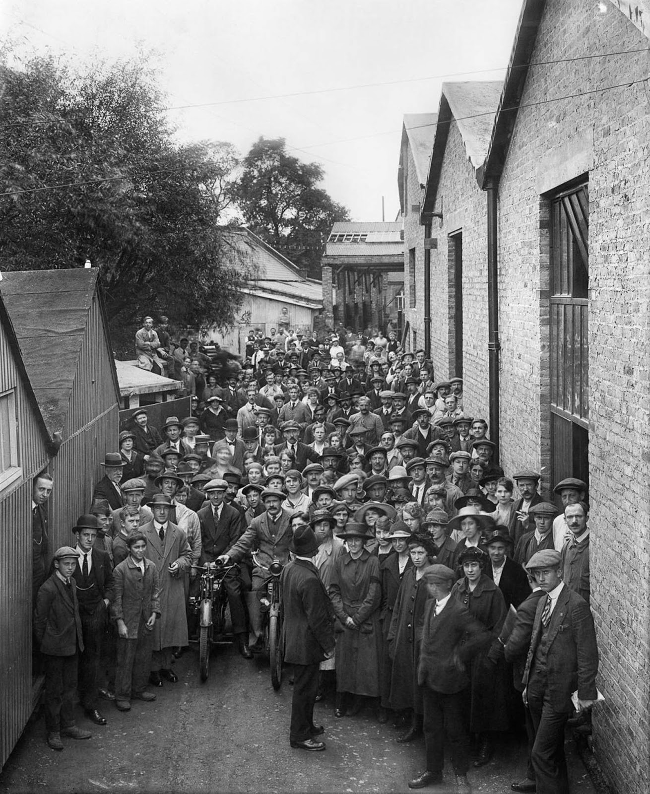 Belgian refugees outside the Belgian Munition Works in London, where they were employed to manufacture explosives for the war effort. 1918.