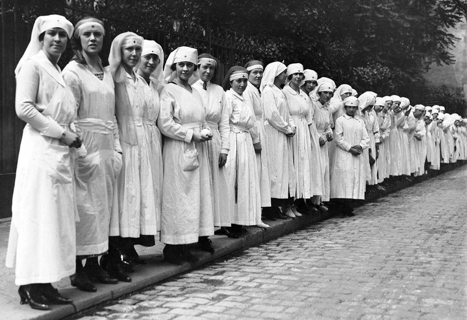 Nurses line up after a fire drill at 60 Rue St. Didier in Paris, where the American Red Cross makes