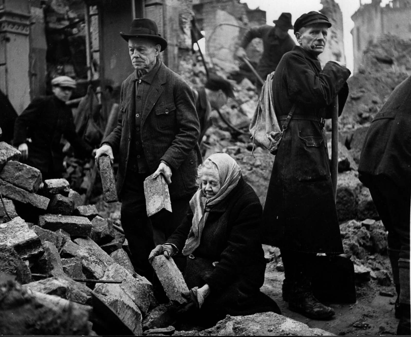 Gustav and Alma Piltz help to clear rubble. 1946.