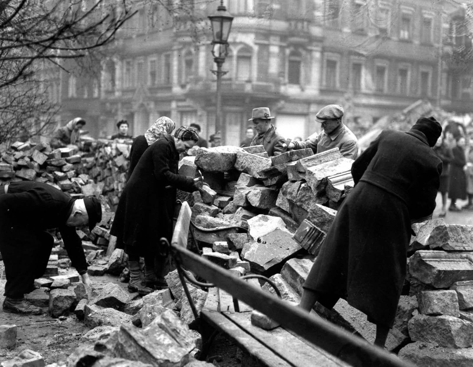 Volunteers clear rubble on a Sunday morning. 1946.