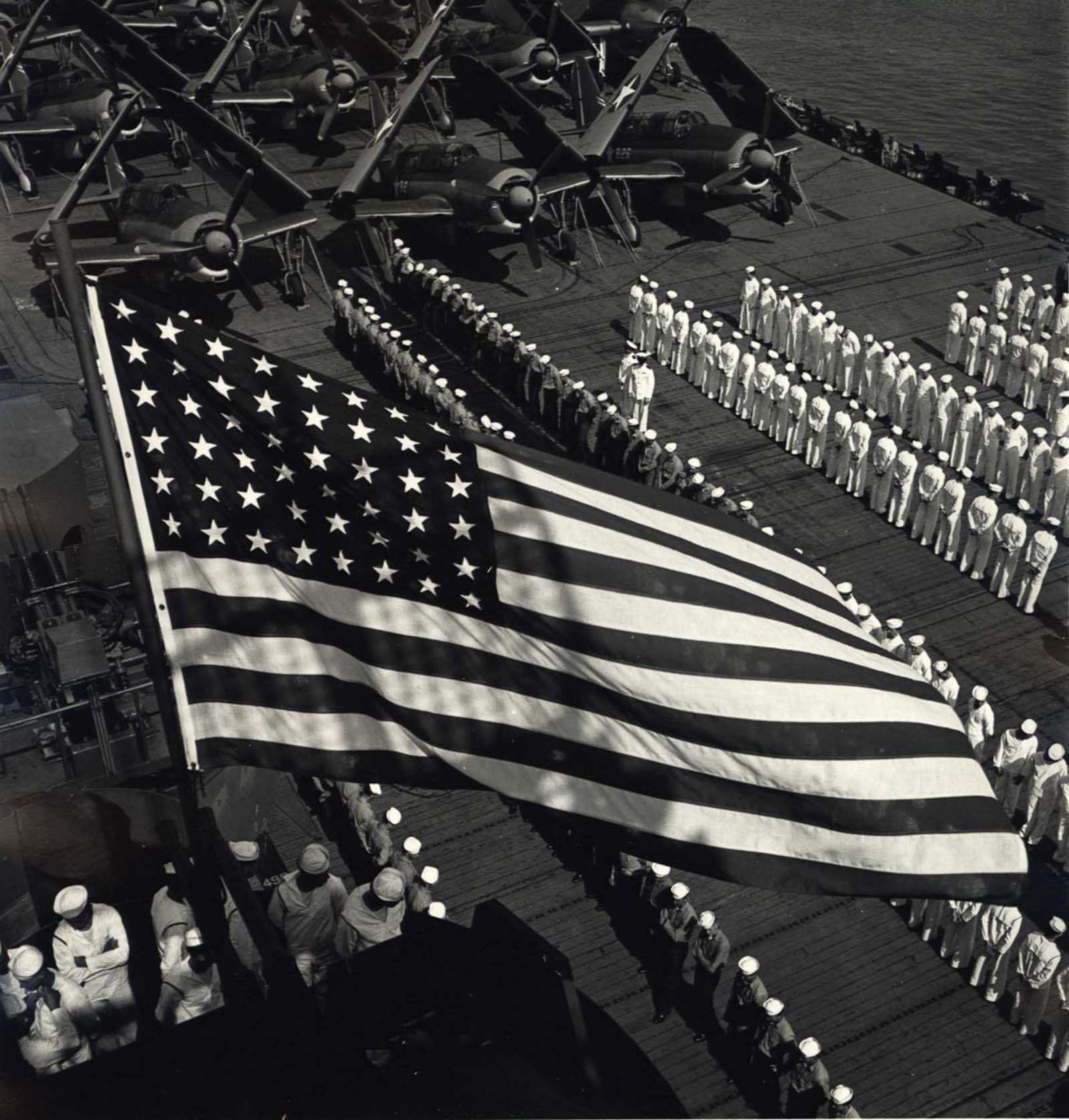 U.S. Navy under American flag, c. 1943.