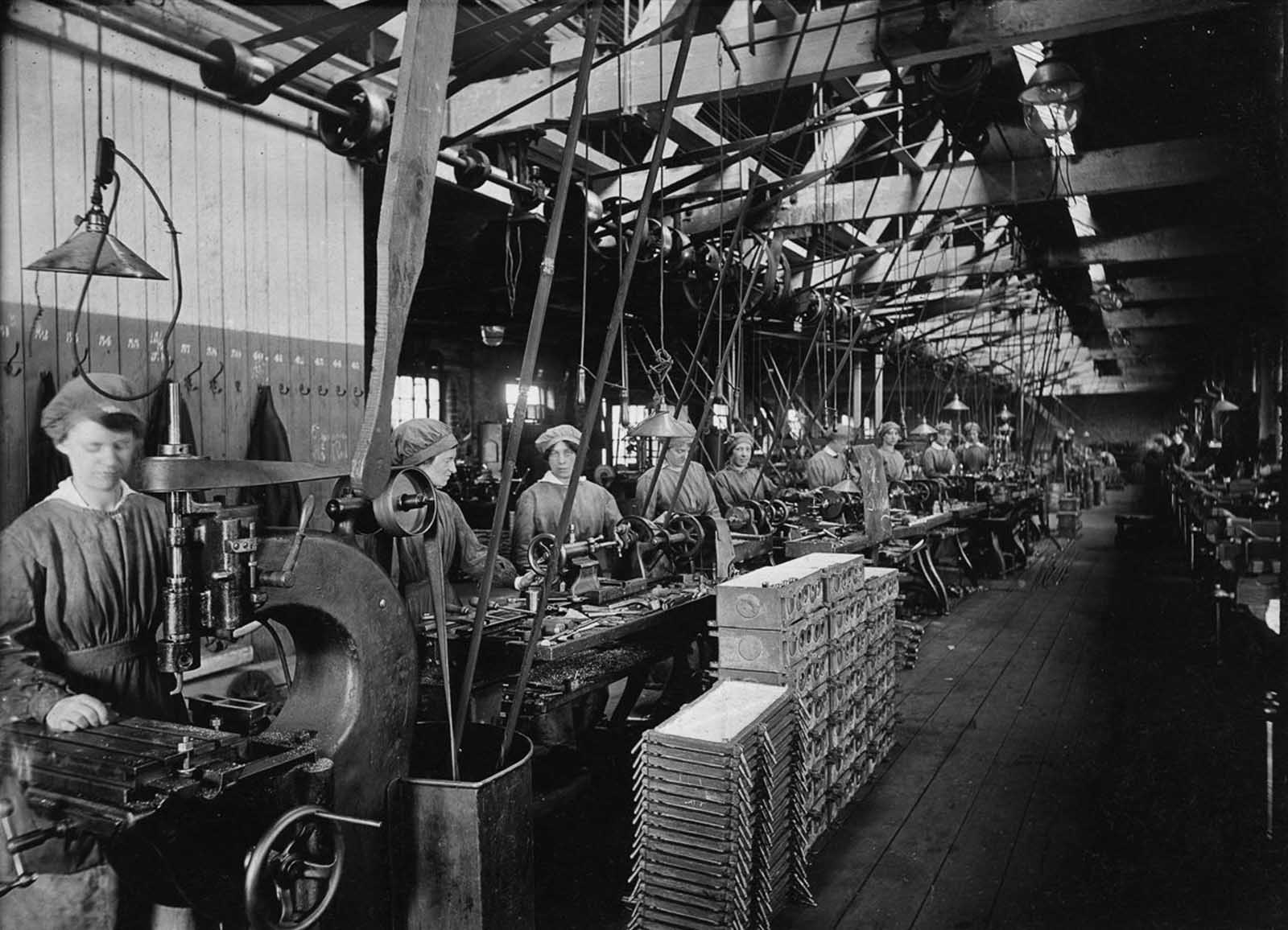 Workers craft electrical fittings.