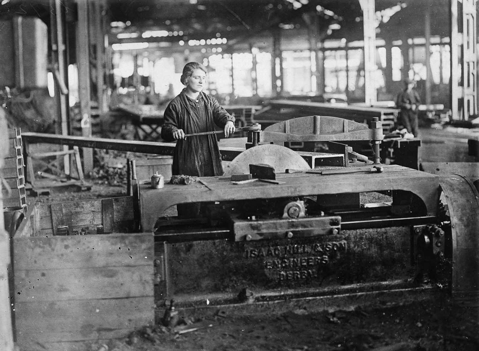 A worker operates a circular saw.