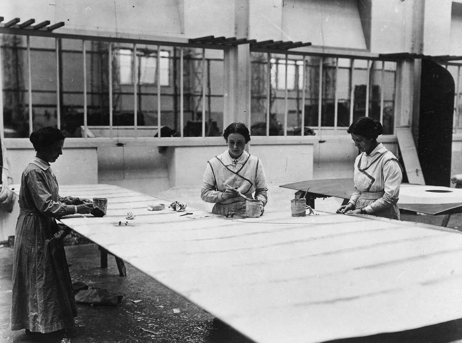 Workers construct and treat airplane wings.