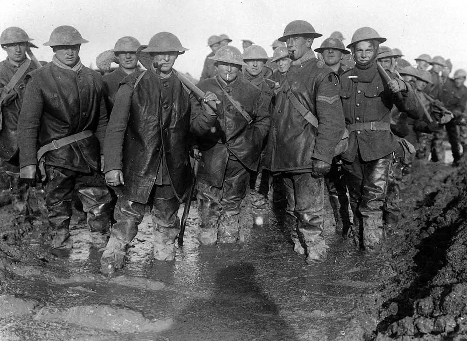 British soldiers standing in mud on the French front lines, ca. 1917.