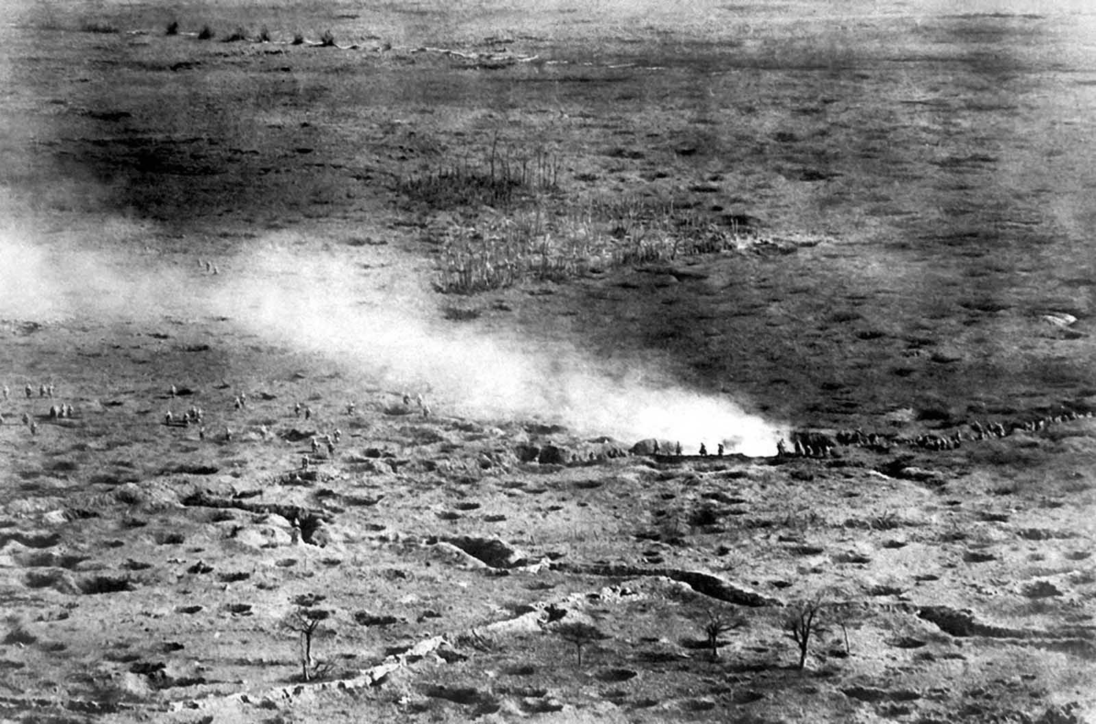 At a height of 150 meters above the fighting line, a French photographer was able to capture a photograph of French troops on the Somme Front, launching an attack on the Germans, ca. 1916. The smoke may have been deployed intentionally, as a screening device to mask the advance.