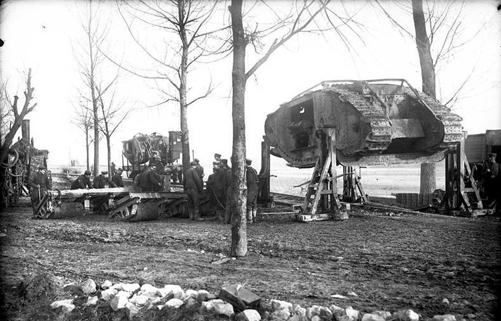 At Cambrai, German soldiers load a captured British Mark I tank onto a railroad, in November of 1917. Tanks were first used in battle during World War I, in September of 1916, when 49 British Mark I tanks were sent in during the Battle of Flers-Courcelette.