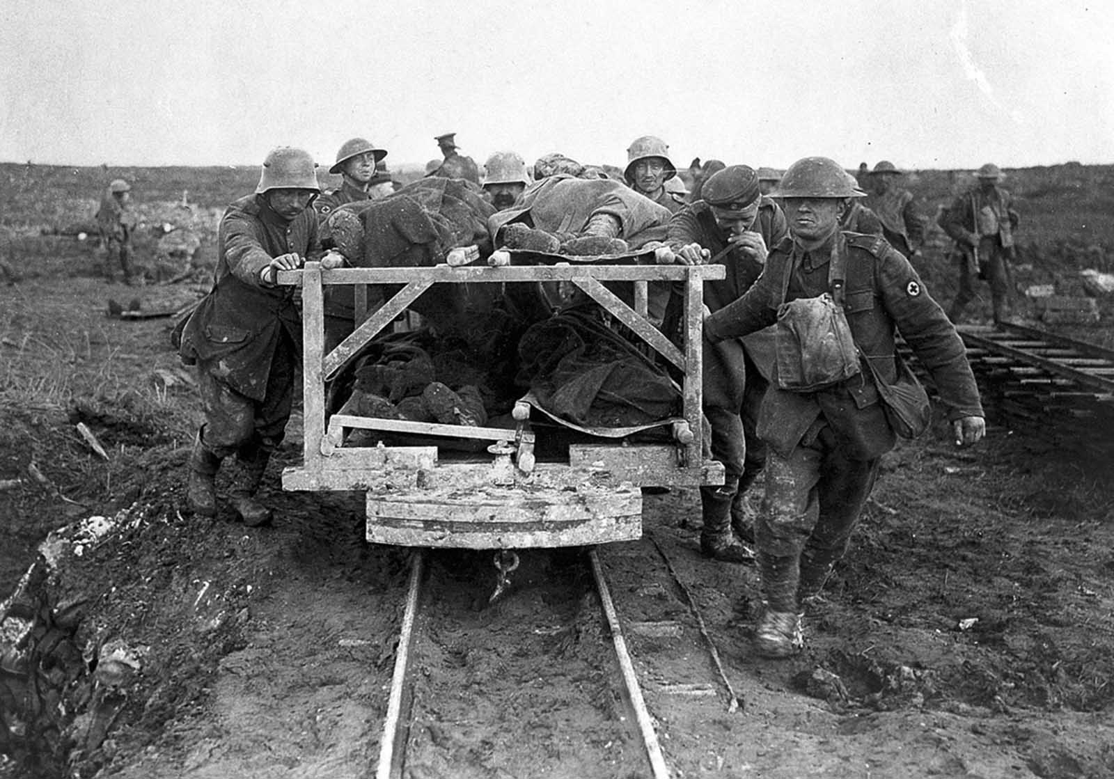 Bringing Canadian wounded to the Field Dressing Station, Vimy Ridge in April of 1917. German prisoners assist in pushing the rail car.