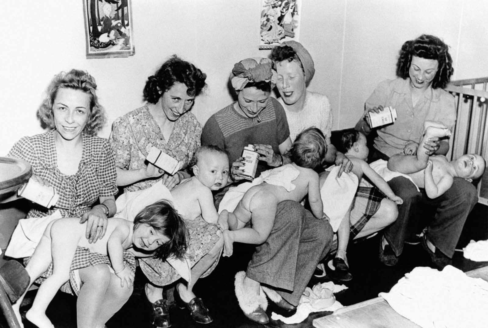 New mothers change their babies' diapers in New York City, 1946.