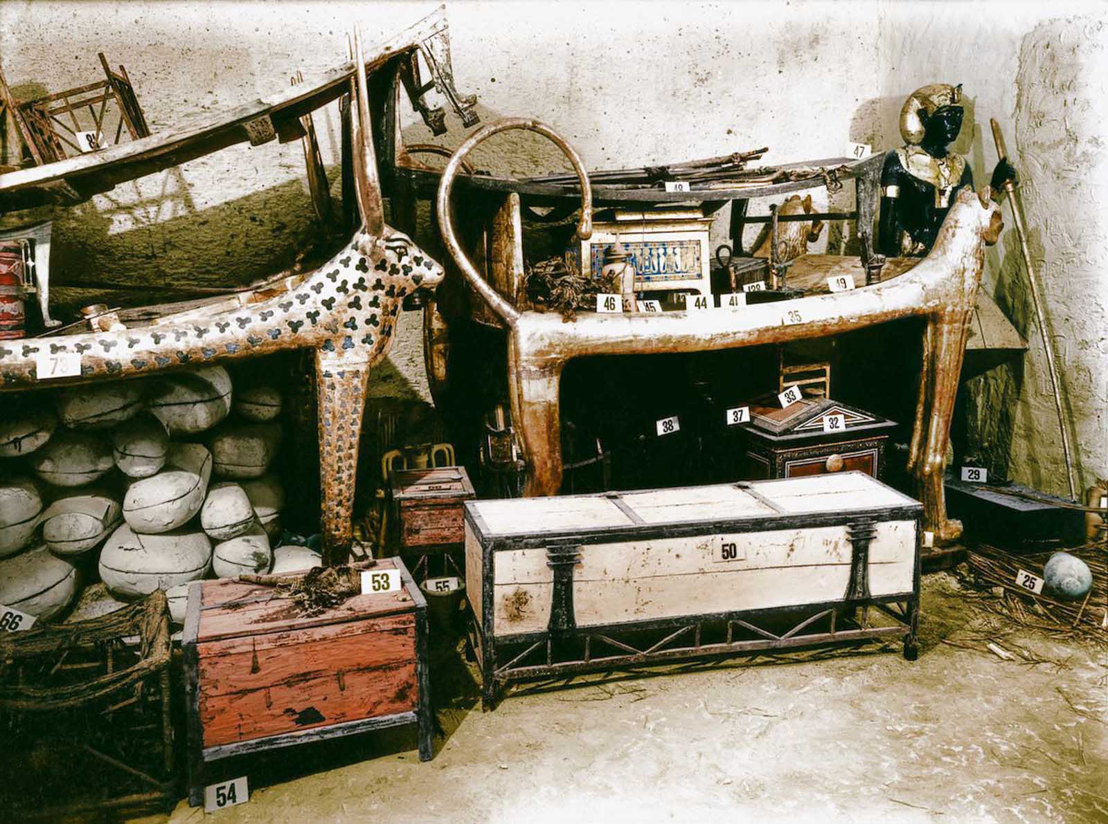 A gilded lion bed and inlaid clothes chest among other objects in the antechamber.