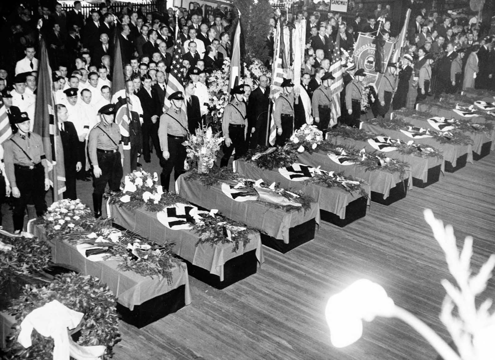 In New York City, funeral services for the 28 Germans who lost their lives in the Hindenburg disaster are held on the Hamburg-American pier, on May 11, 1937. About 10,000 members of German organizations lined the pier.