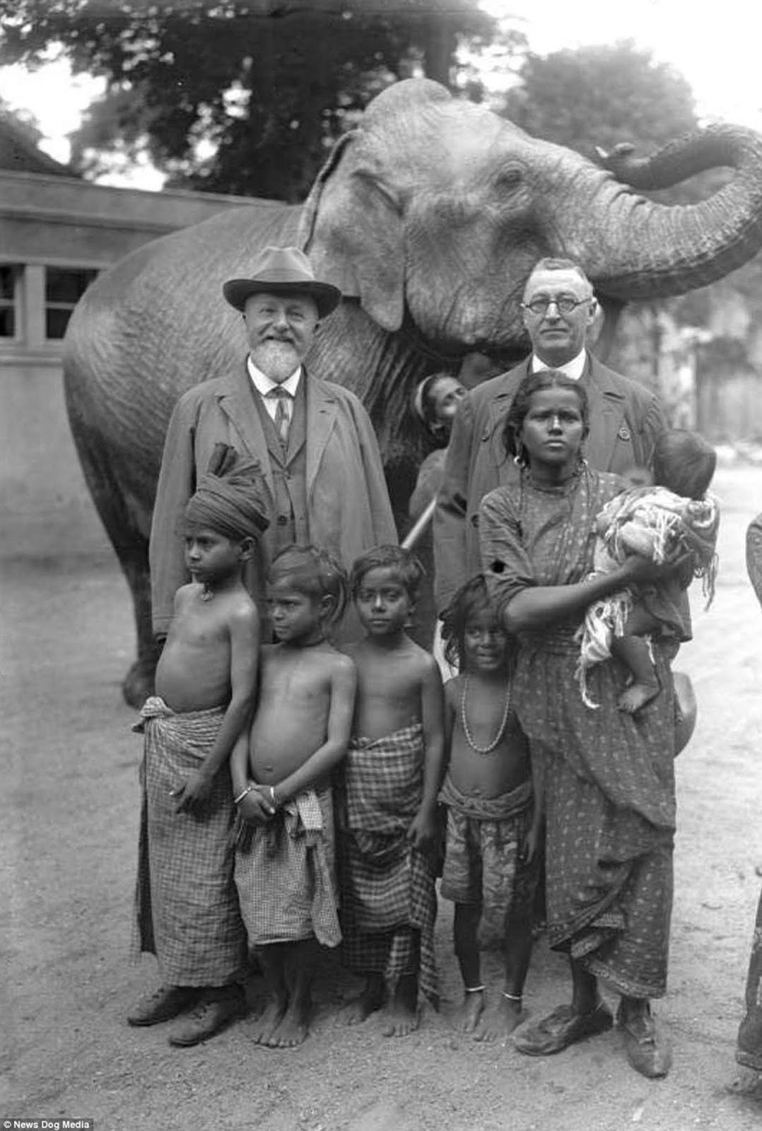 German zoologist Professor Lutz Heck is pictured (left) with an elephant and a family he brought to the Berlin Zoo, in Germany in 1931.
