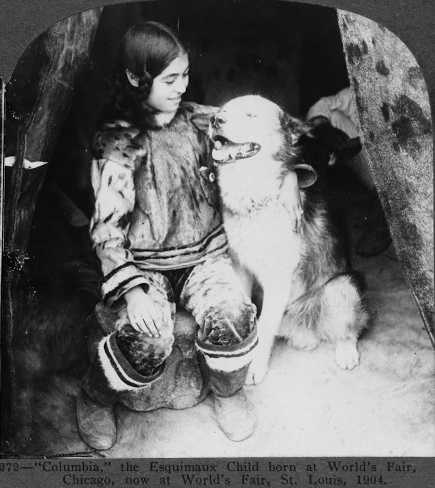 This Eskimo child, pictured with a dog, was born at World's Fair in Chicago and is pictured after being transferred to World's Fair, St. Louis in 1904.