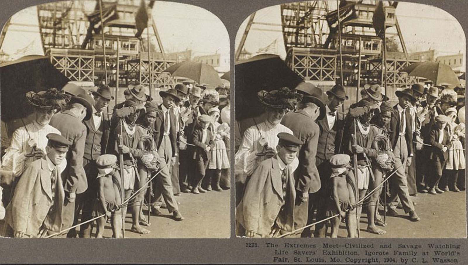 A photograph crudely named 'The extremes meet - civilized and savage watching life savers' exhibition' shows a scene from the World's Fair St. Louis, 1904, with tourists watching people deemed 'primitive'.
