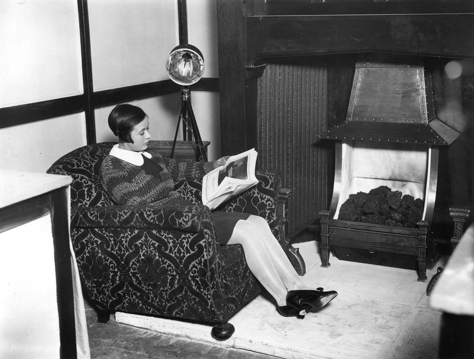 A woman under a sunray lamp, on show at the first International Exhibition of Light and Heat in Medicine at Central Hall, Westminster. 1927.