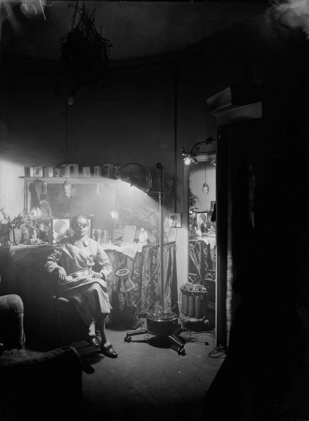 American comedienne Florence Mills basks in the glow of a sun lamp in her dressing room. 1925.