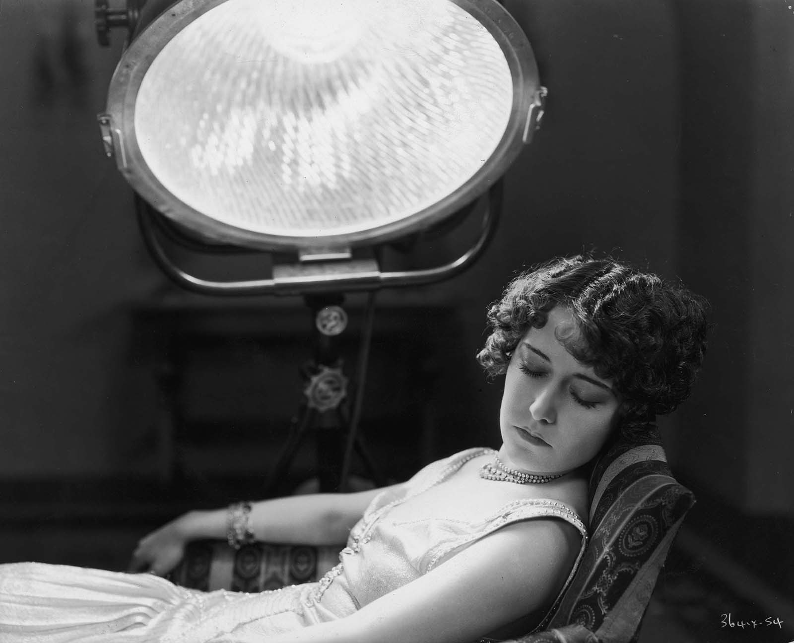 Hollywood film star, Dorothy Sebastian (1903 – 1957) undergoing treatment for bronchial congestion with a sun-ray lamp at MGM studios. 1930.