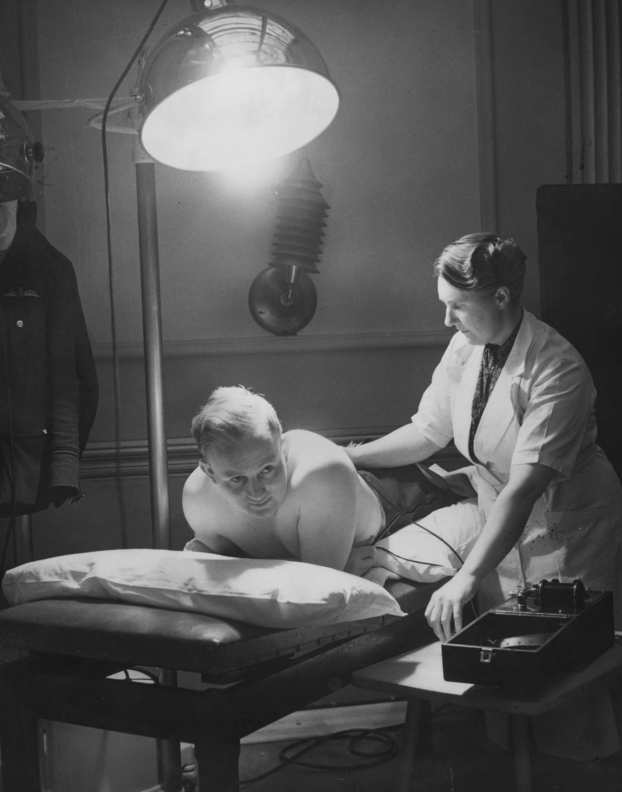 An RAF Flying Officer receiving Sun-Ray and electrical treatment after suffering a broken back. 1941.