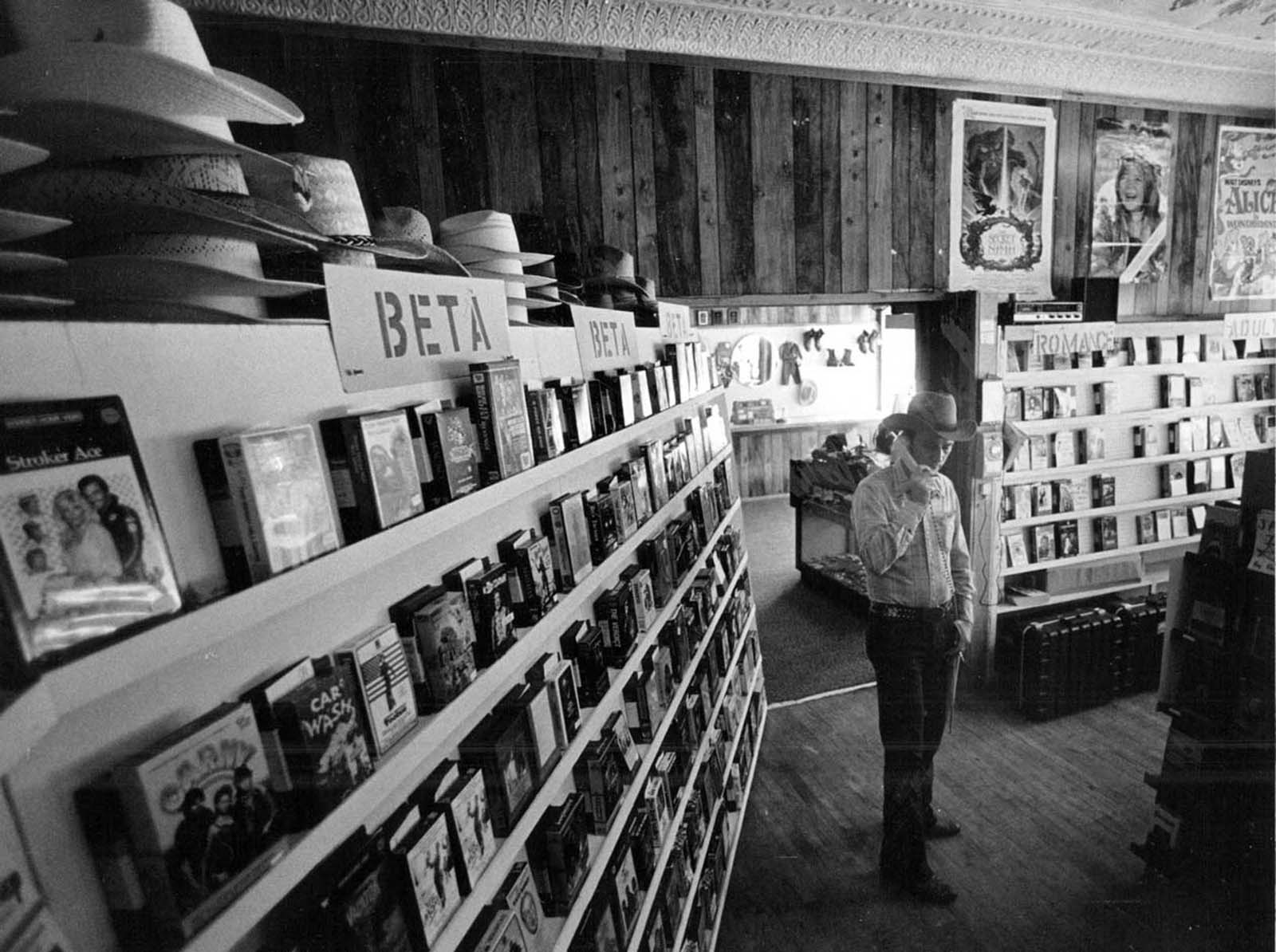 In Castle Rock, Colorado a man answers the phone in the video rental section of his store – including Betamax. 1984.