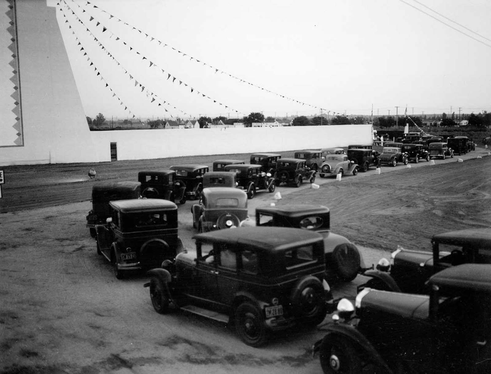 Line of automobiles at opening day of Drive-In Movie Theater.