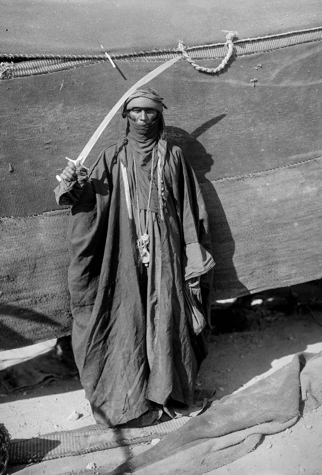 A Bedouin man showing his sword.
