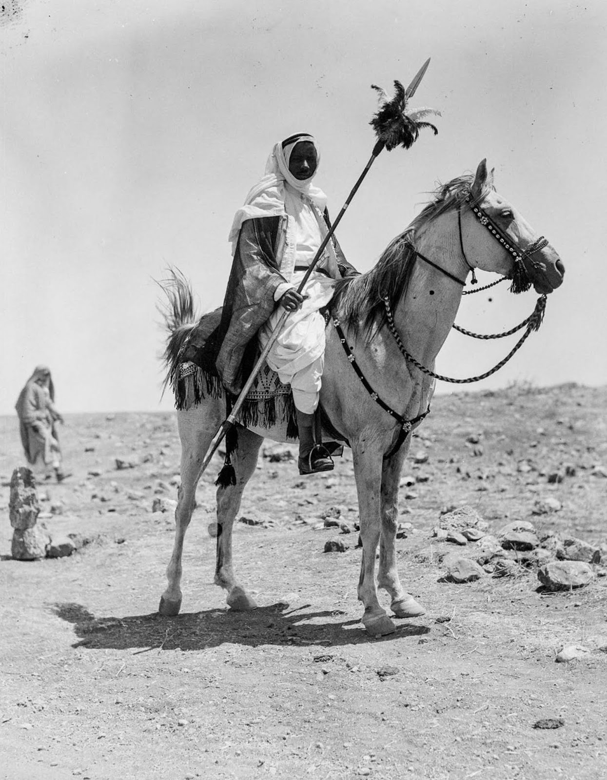 A Bedouin man riding his horse.