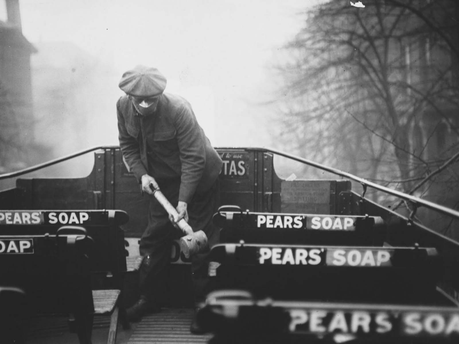 A man sprays the floor of an open style bus with an anti-flu spray. 