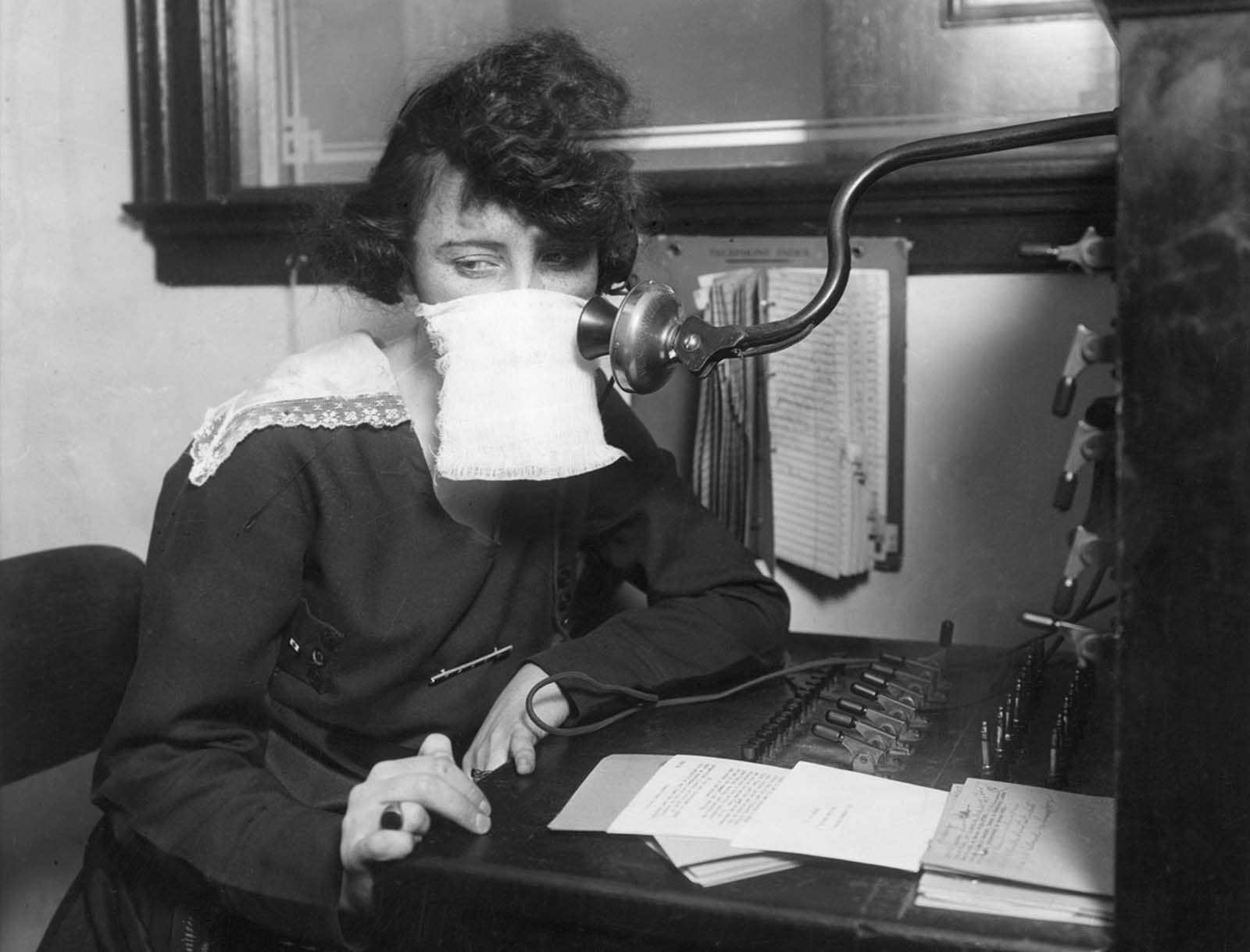 A telephone operator with protective gauze in 1918.