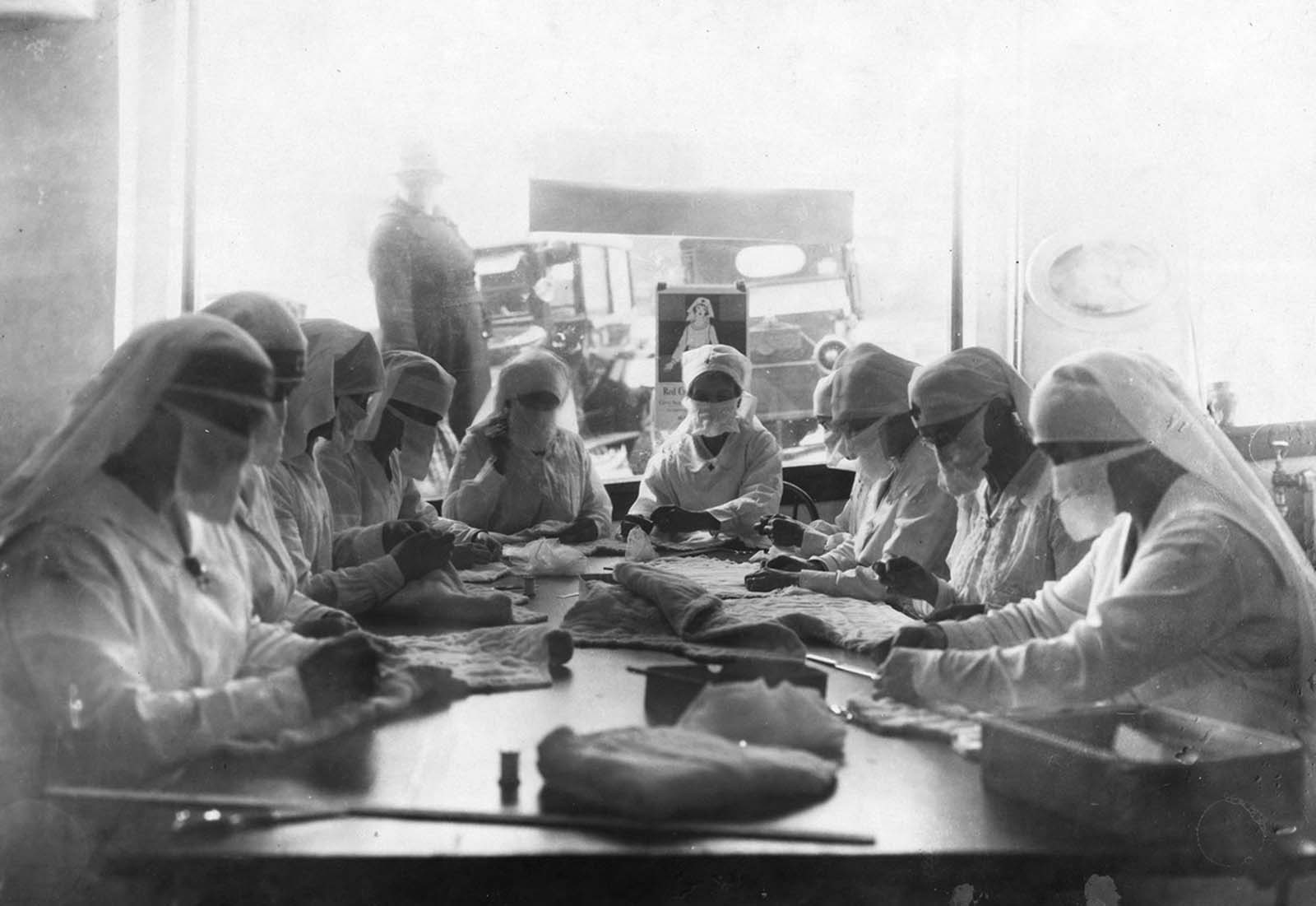 Women at work in Red Cross rooms in Seattle, Washington, with influenza masks on.