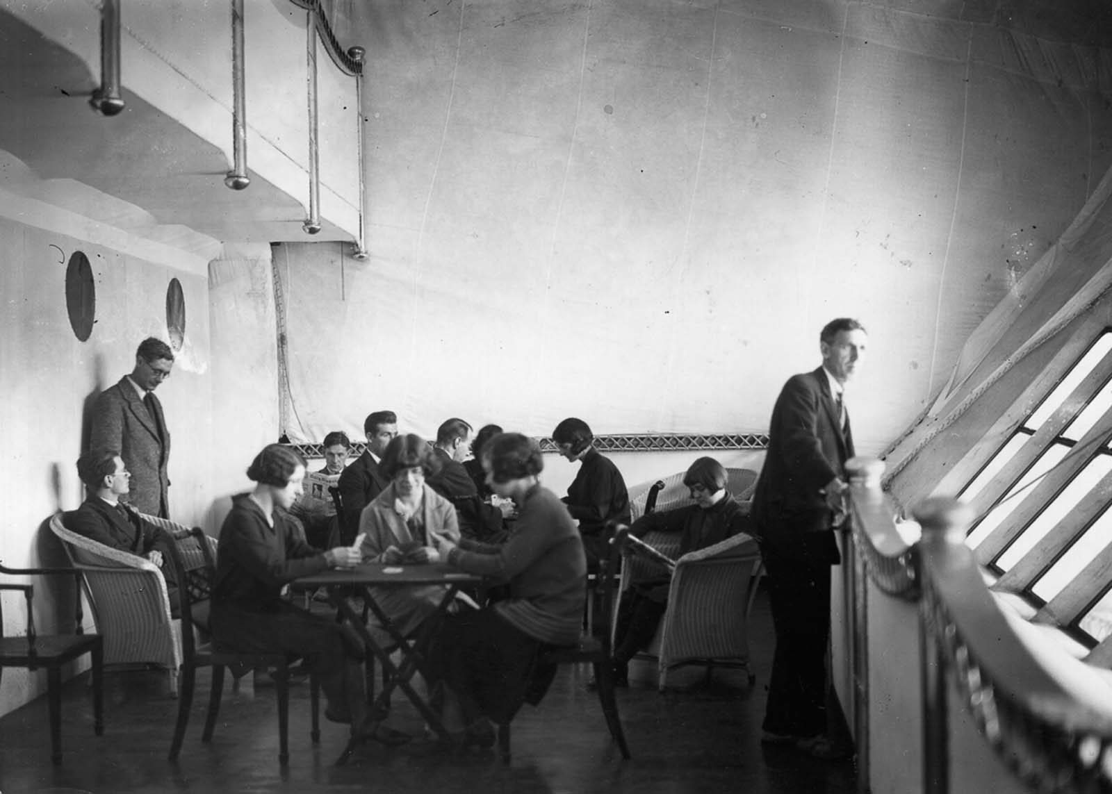 Passengers pass the time in the R-100's lounge. 1929.