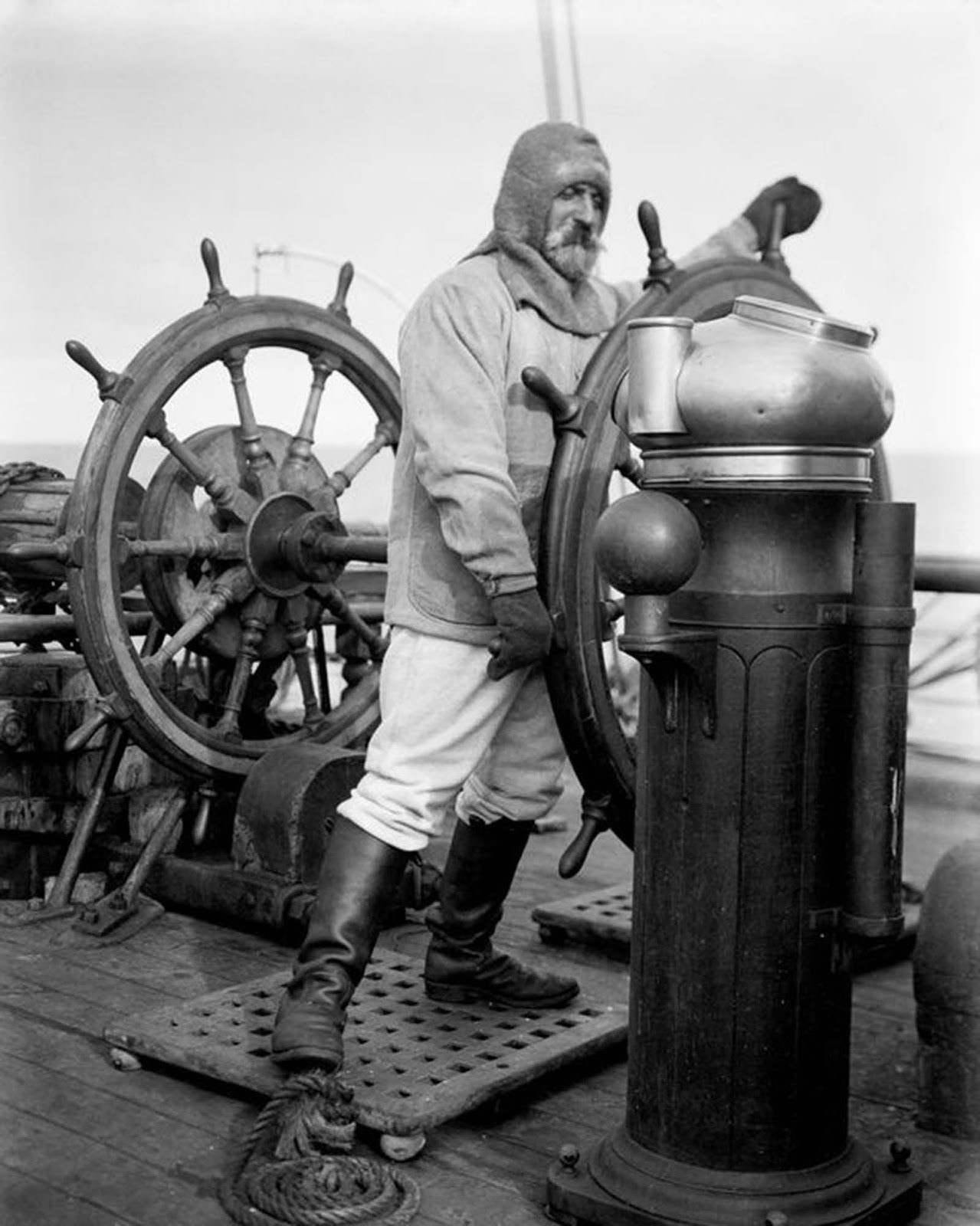 Able seaman Mortimer McCarthy at the wheel of the Terra Nova. 1910.