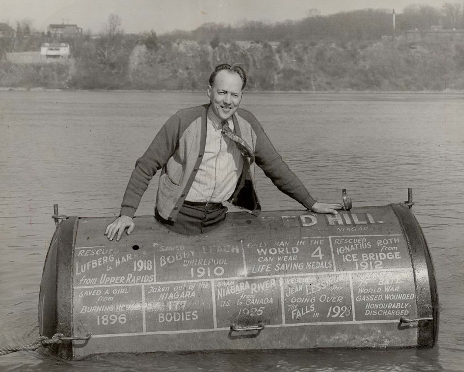 Red Hill Jr. with his father's 780-pound steel barrel, which he took through the rapids below the falls. 1945.