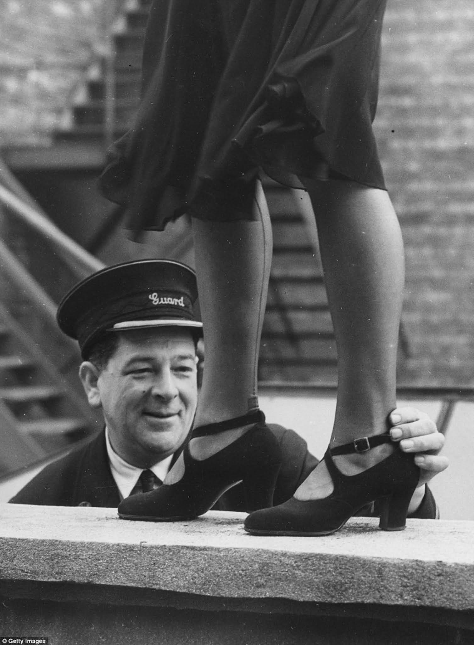 Railway guard George Wiltshire, judge of an ankle competition organised by the Women's Section of the British Railways Social Club at Oxford, with the winner, Elsie Chapman, in 1949.