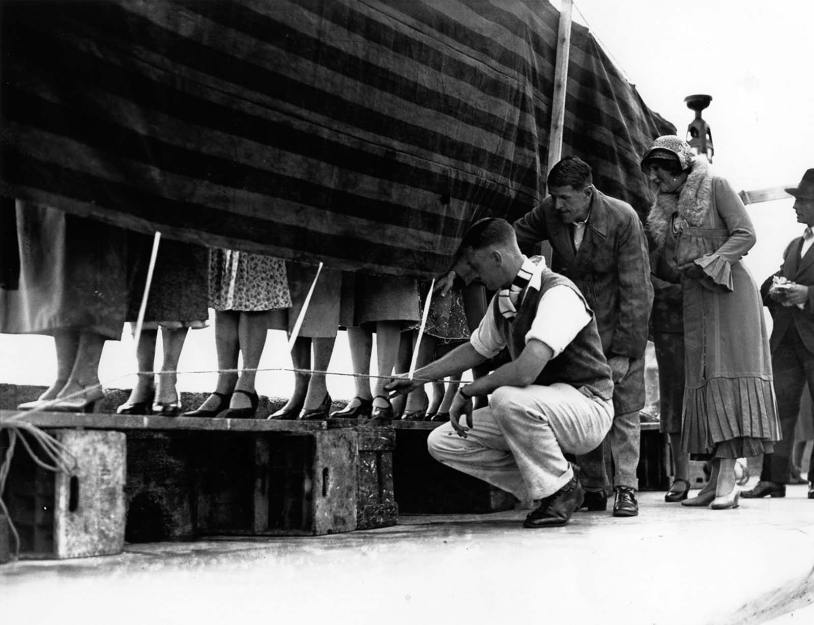 Men judge women's ankles at a competition in Kent, England. 1932.